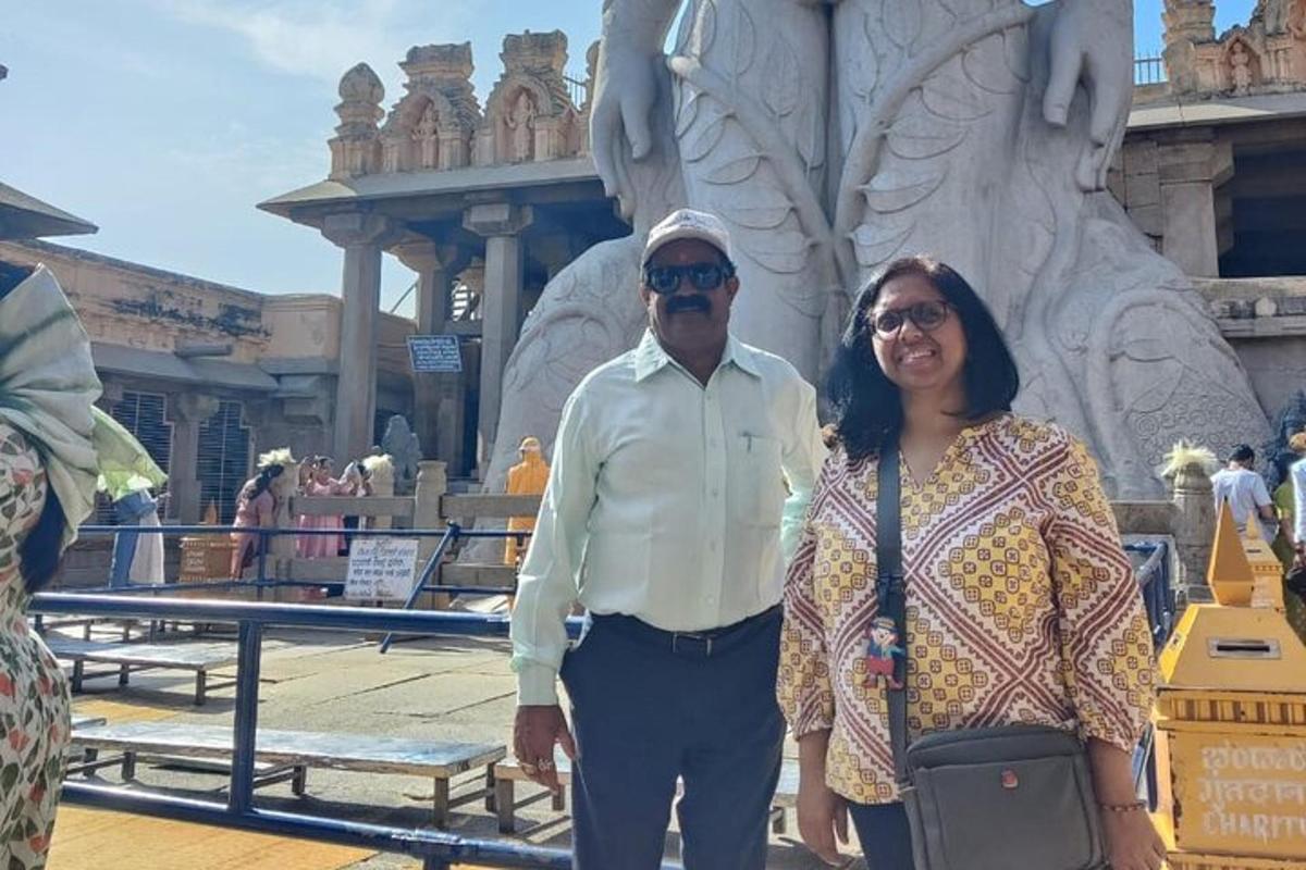 a man and a woman standing in front of a statue