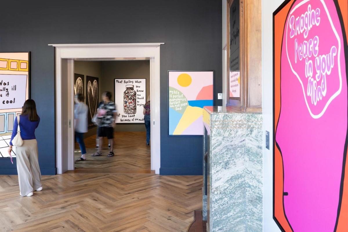 a group of people looking at art in a museum