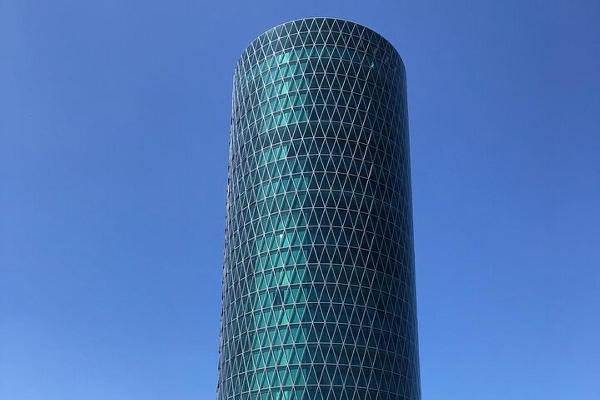 a green building with a blue sky in the background