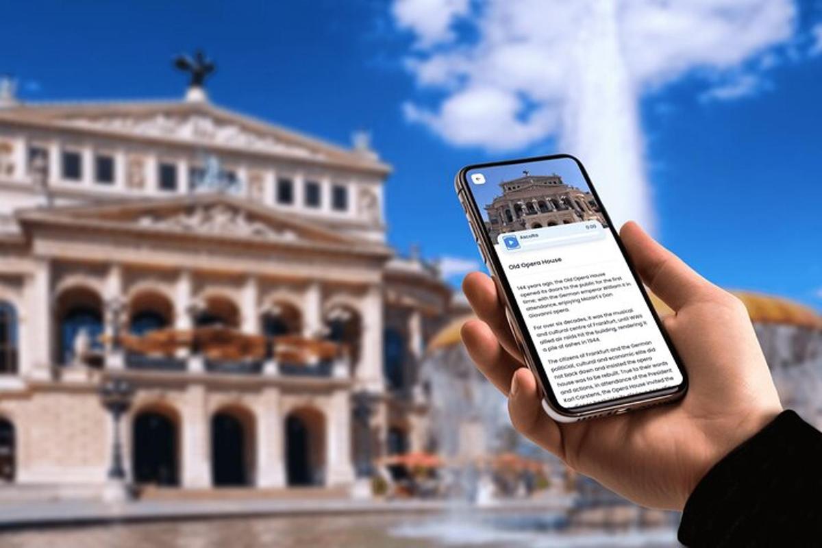 a person holding a cell phone in front of a building