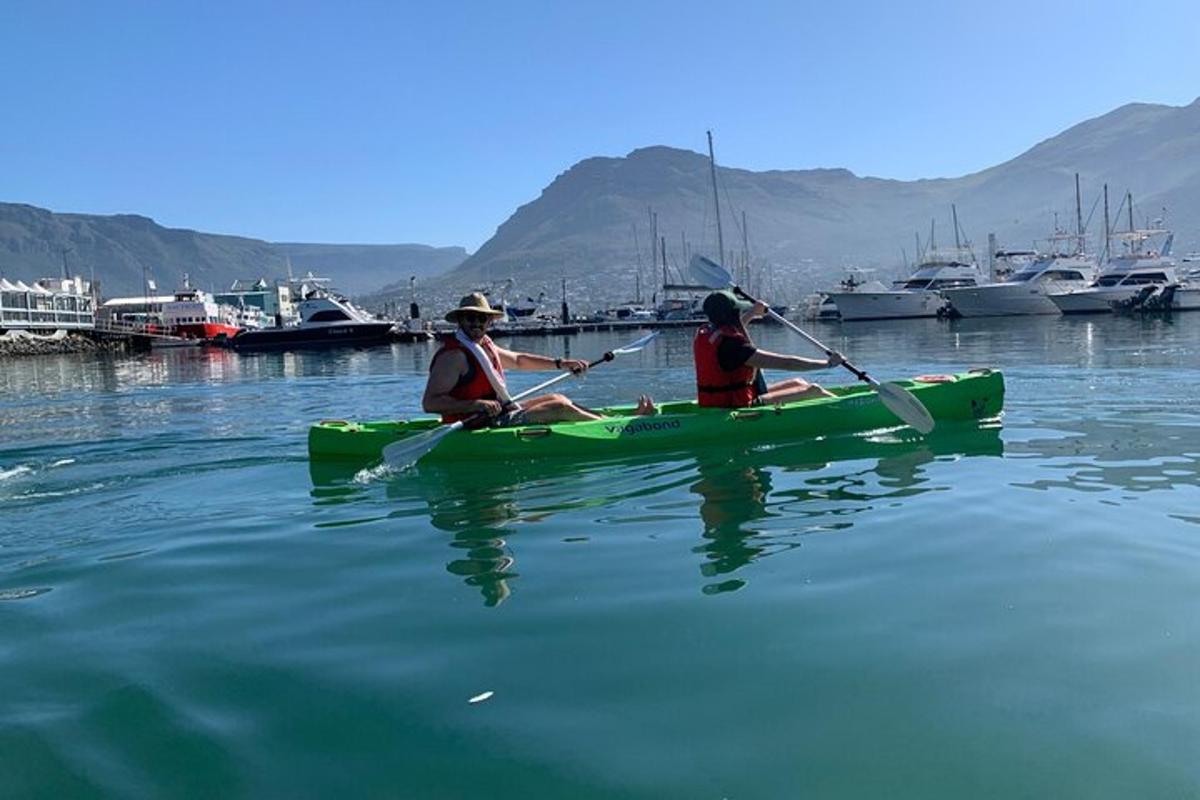 two people in a green kayak in the water
