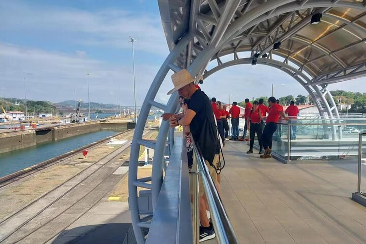Ένας άντρας που στέκεται σε μια γέφυρα κοιτάζοντας το κινητό του