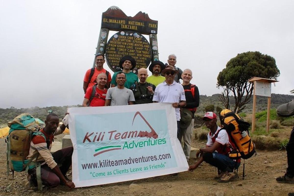a group of people standing in front of a sign