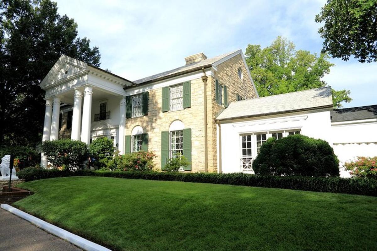 a large white house with a grass yard