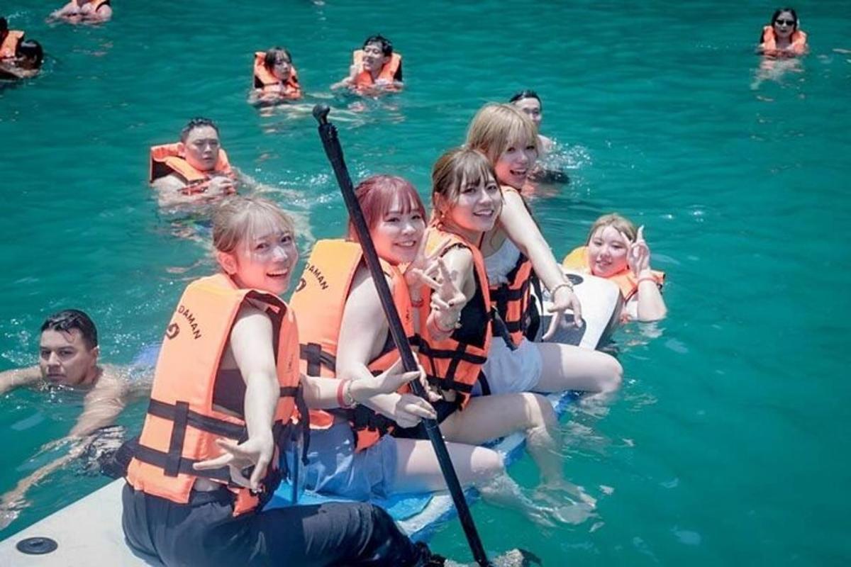 a group of girls in the water on a raft