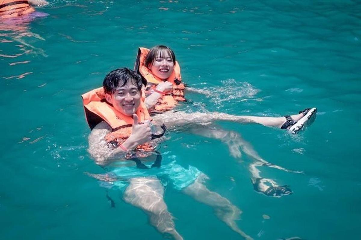 two people in the water wearing life jackets