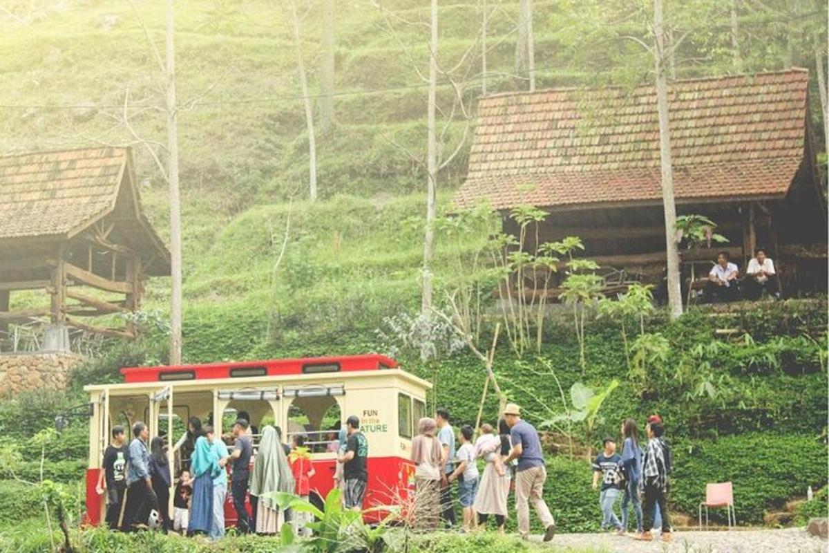 a group of people standing outside of a bus