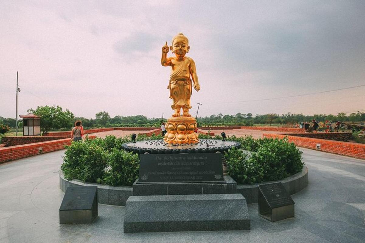 a statue of a boy sitting on top of a monument