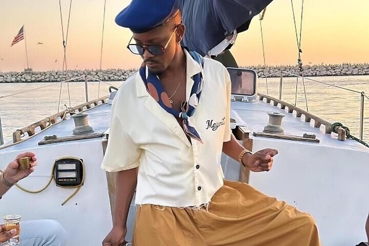 a man in a hat standing on a boat