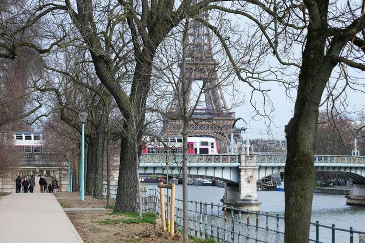 a bridge over a river with a tower in the background