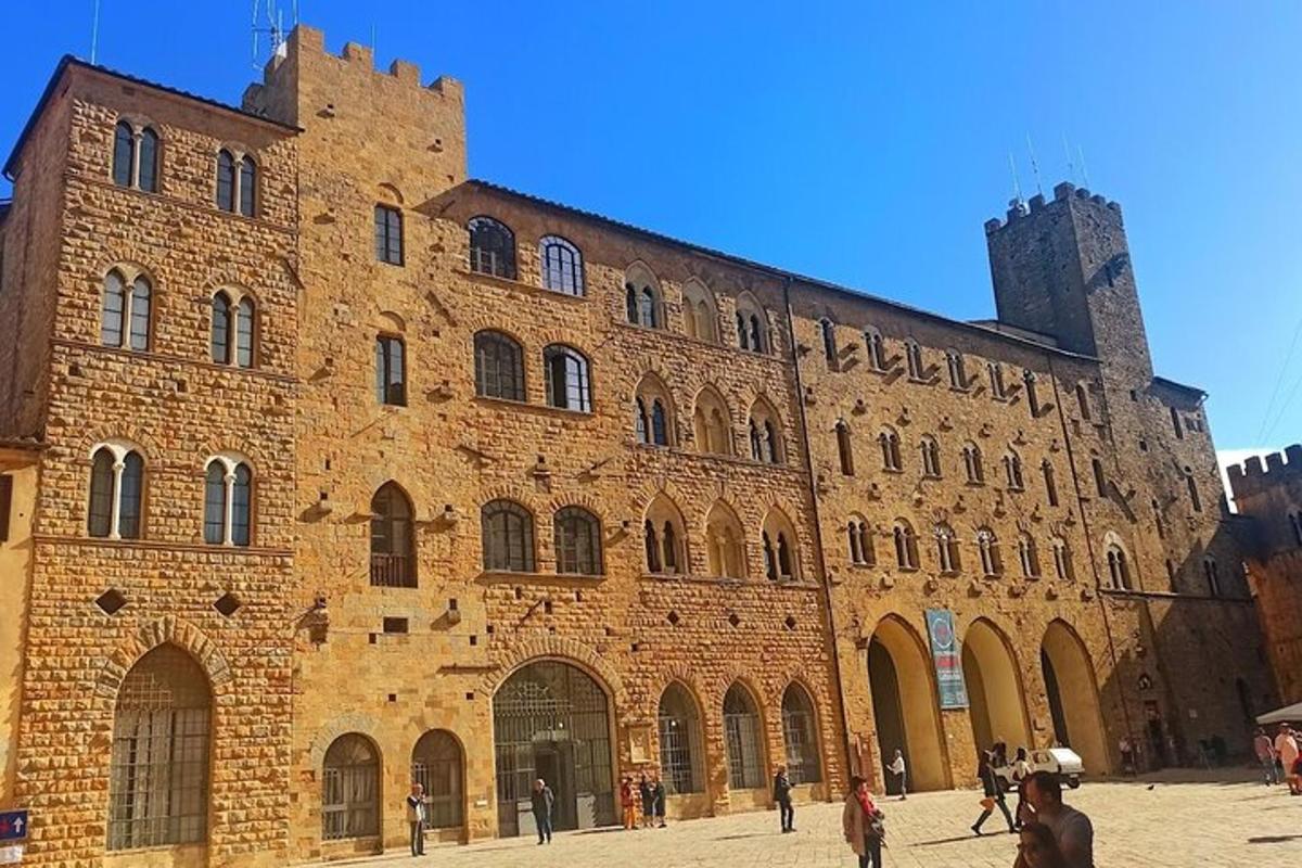 a large brick building with people walking in front of it