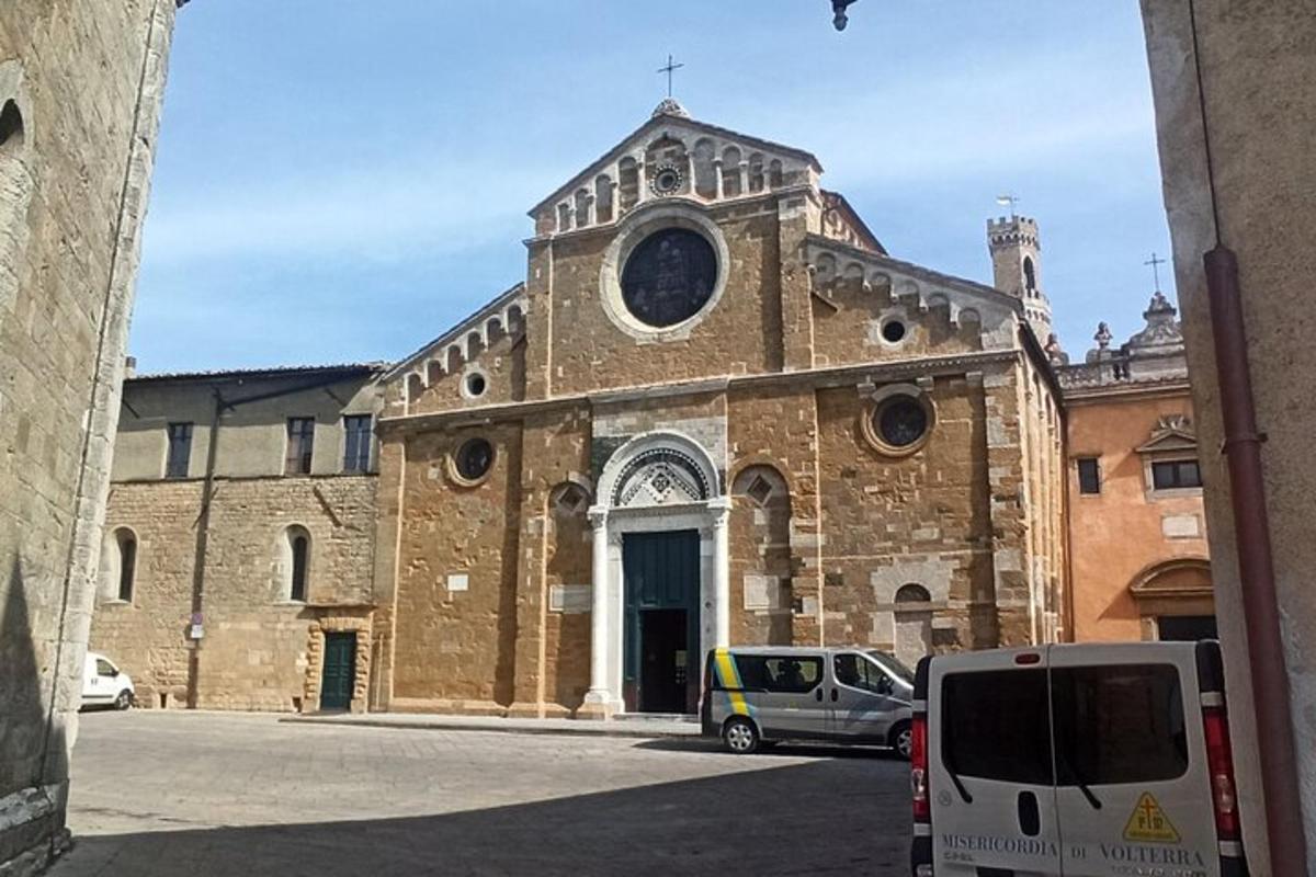 an old stone church with a car parked in front of it