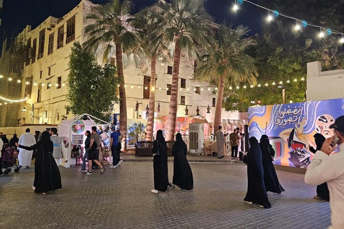a group of women walking down a street at night