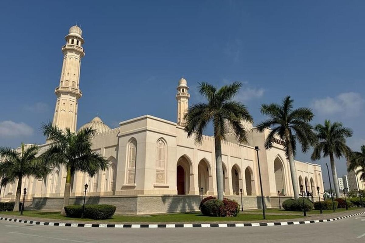 a building with a mosque with palm trees in front