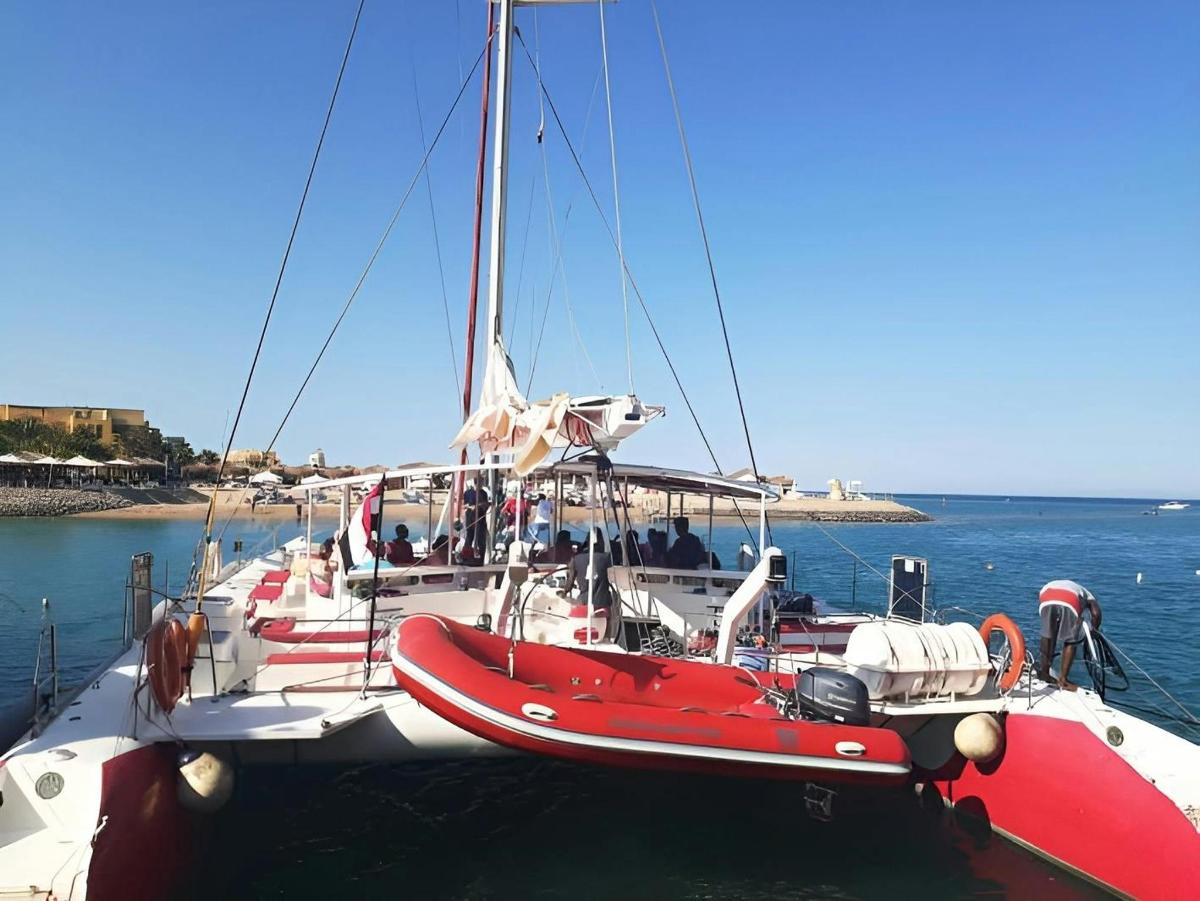 a red and white boat is docked in the water