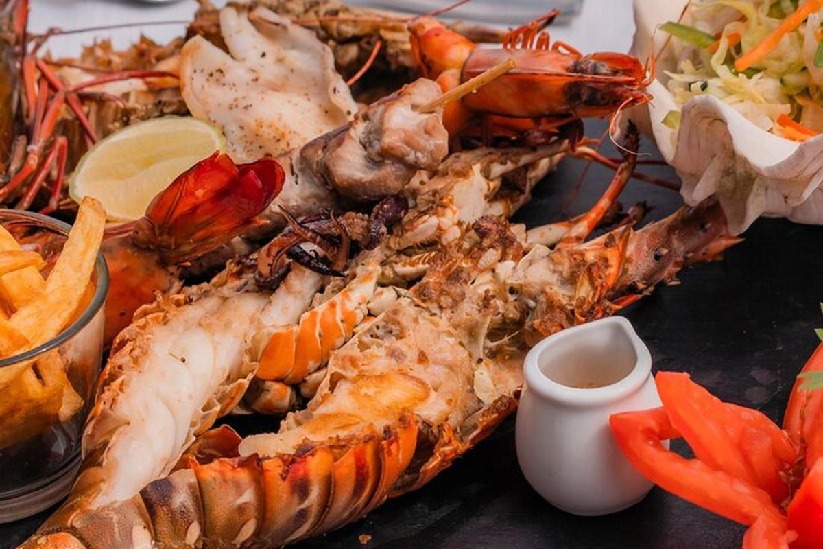 a plate of food with lobsters and vegetables on a table