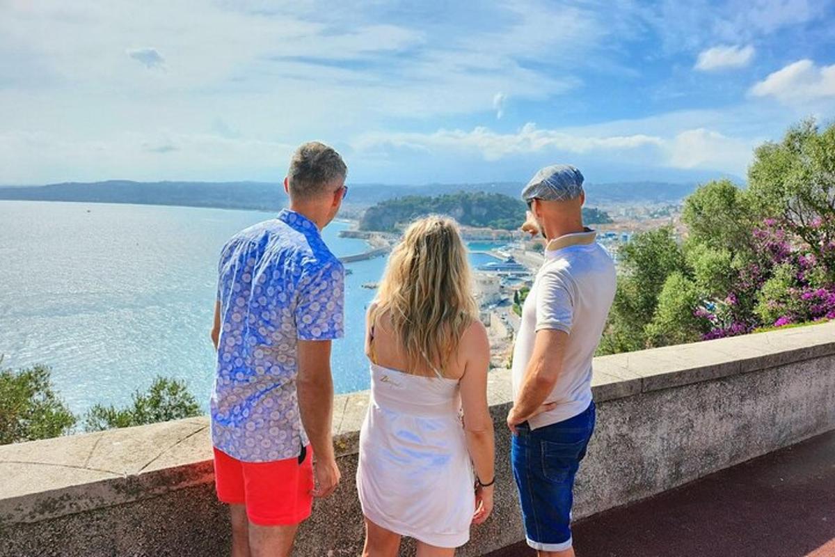 tre persone in piedi su una sporgenza che guardano l'acqua