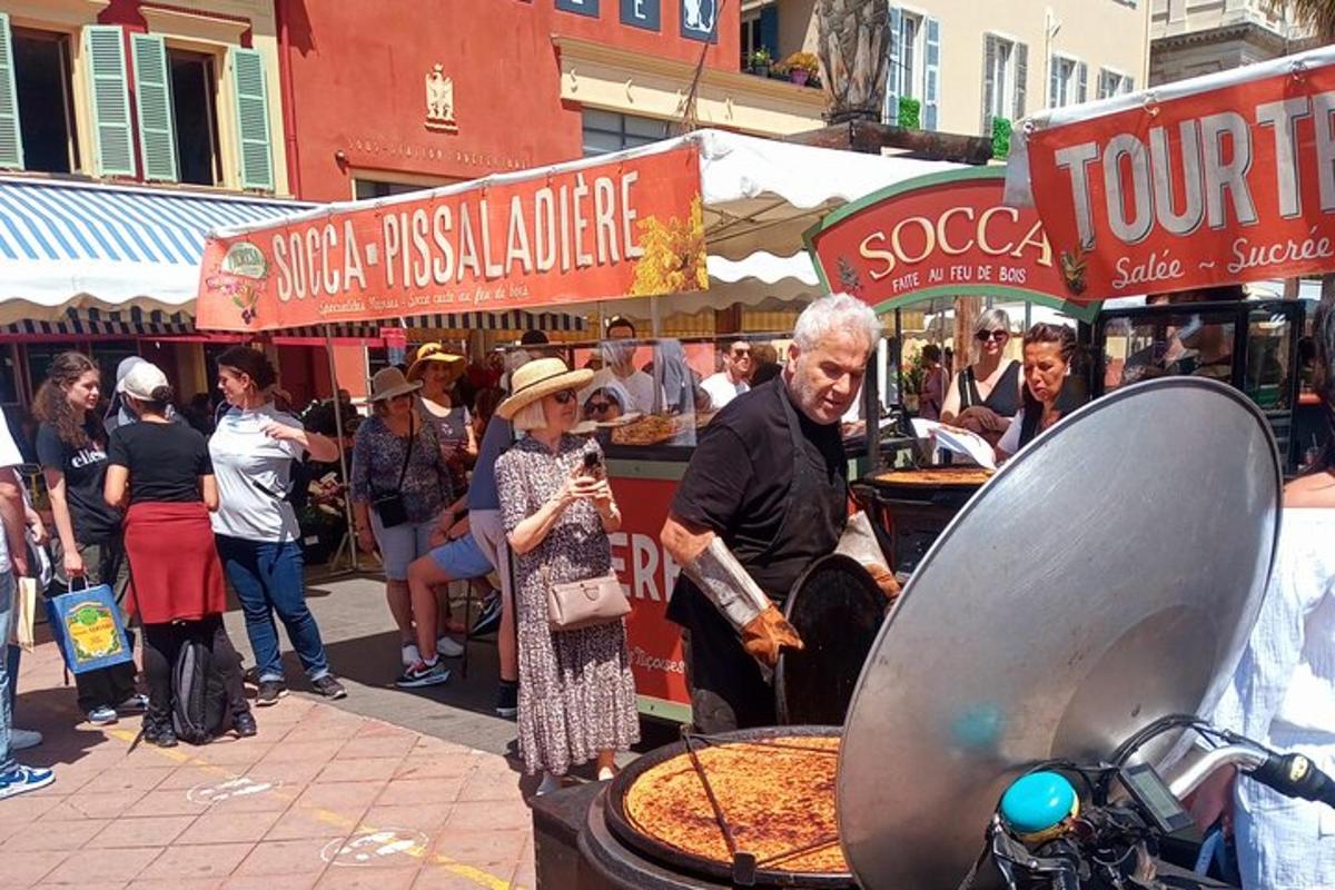 a group of people standing around a pizza stand