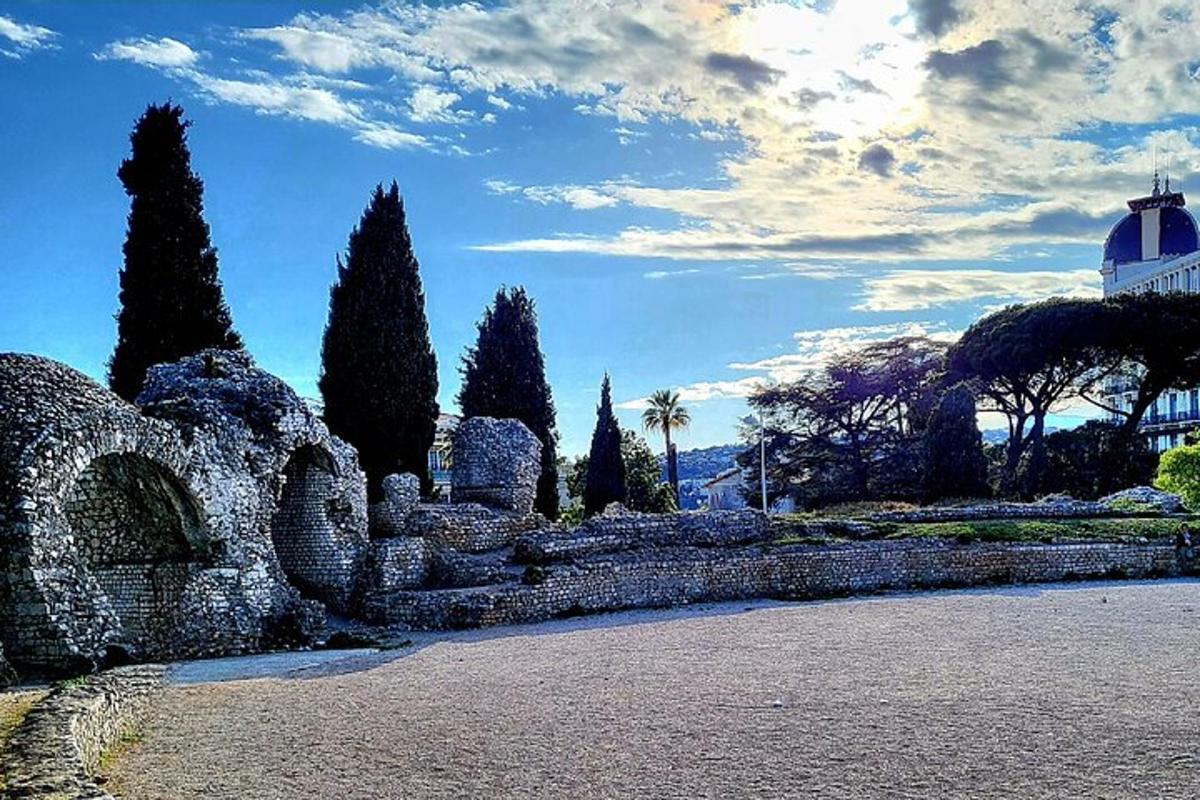 un muro di pietra con alberi e un edificio