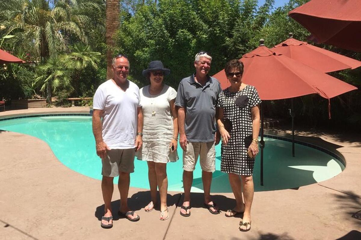 a group of people standing in front of a pool
