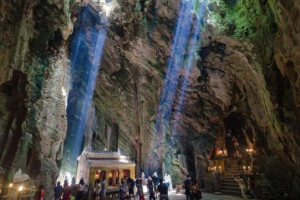 a group of people standing in front of a cave