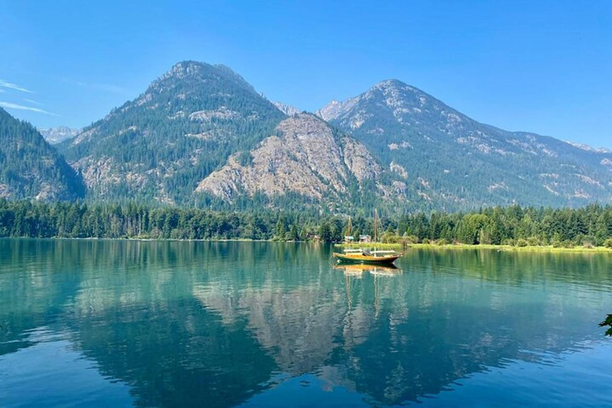 a boat on a lake with mountains in the background