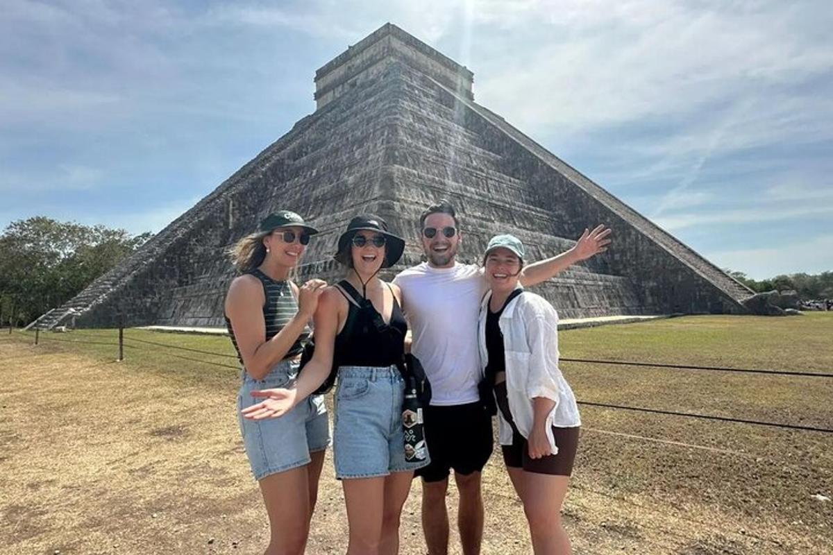 a group of people standing in front of a pyramid