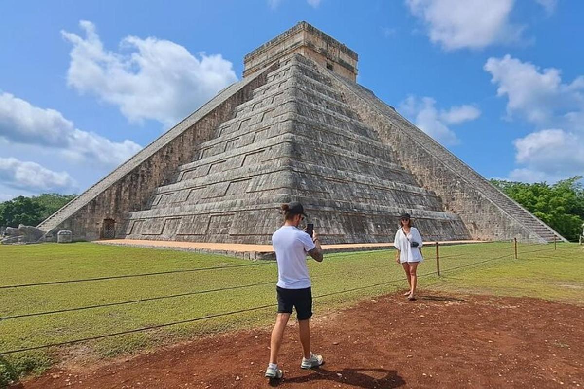 two men standing in front of a pyramid