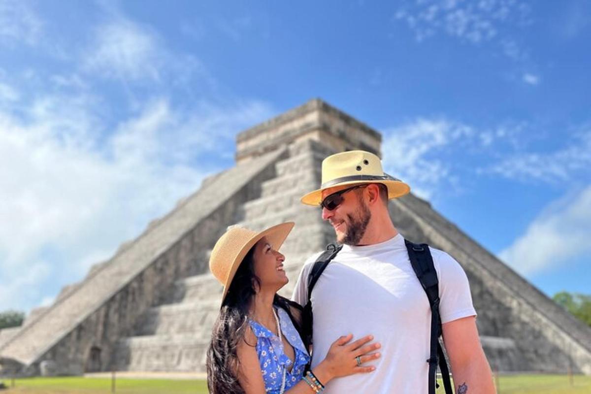 a man and a woman standing in front of a pyramid
