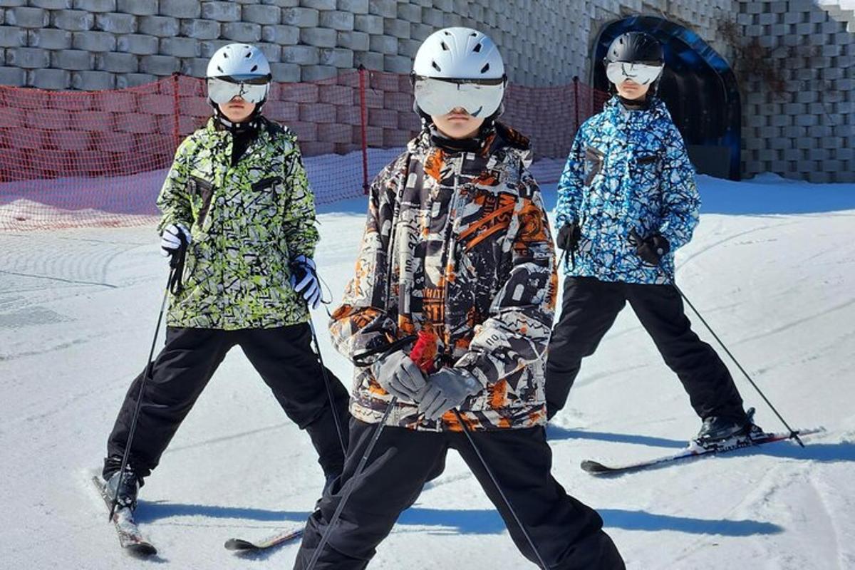 three people are standing on skis in the snow