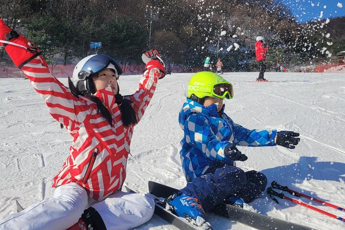 two young children are playing in the snow