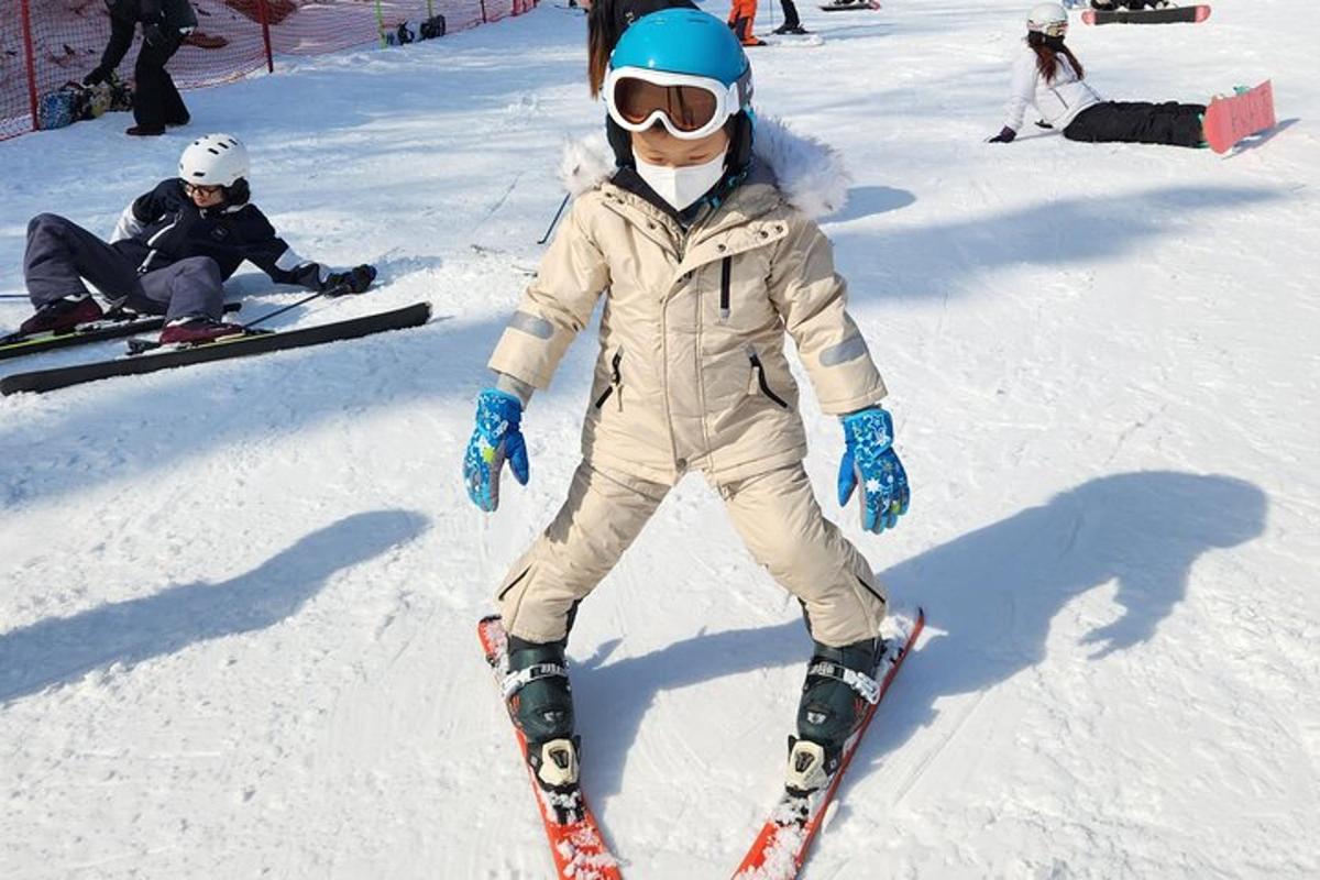 a young child is standing on skis in the snow