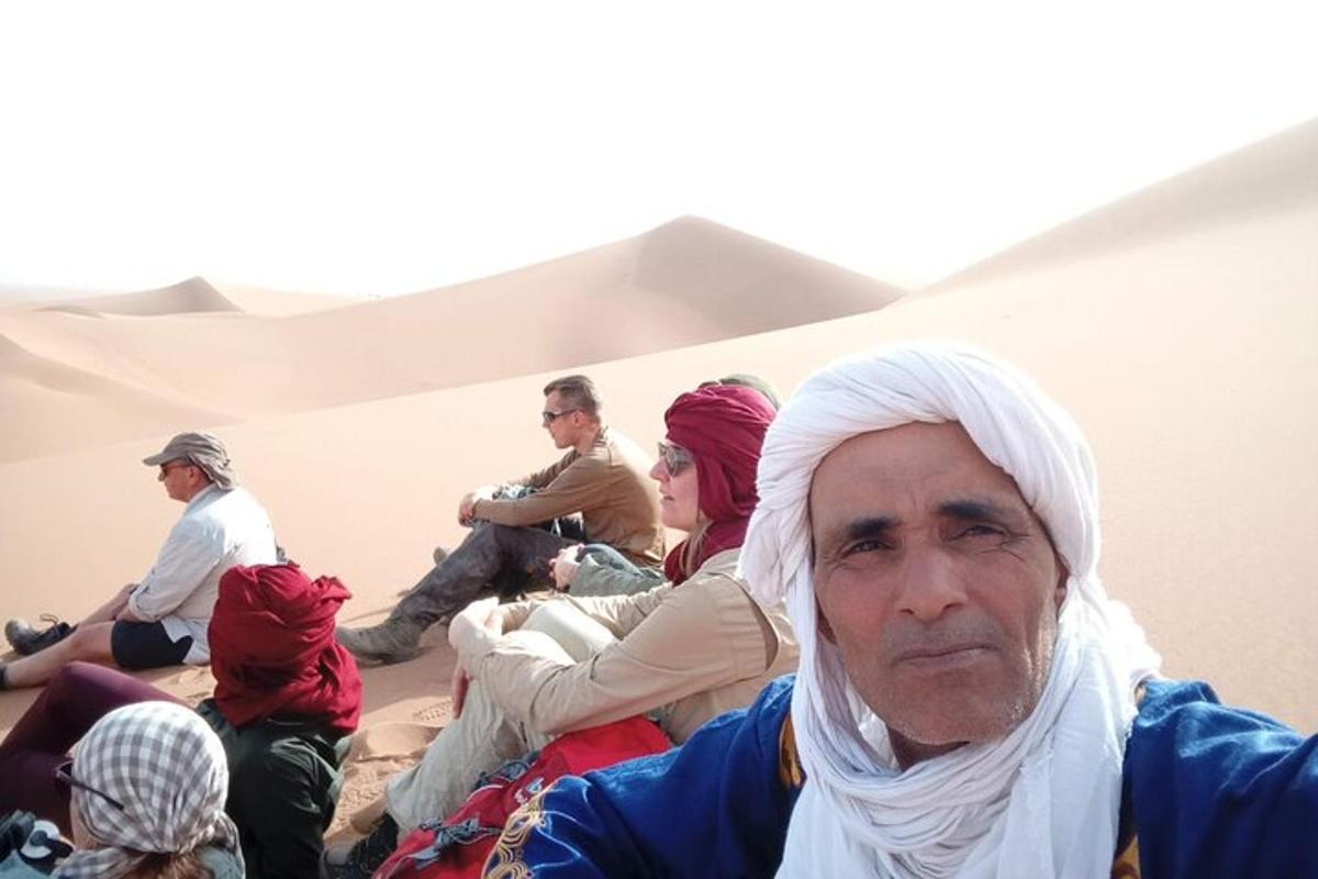 a group of people sitting in the desert