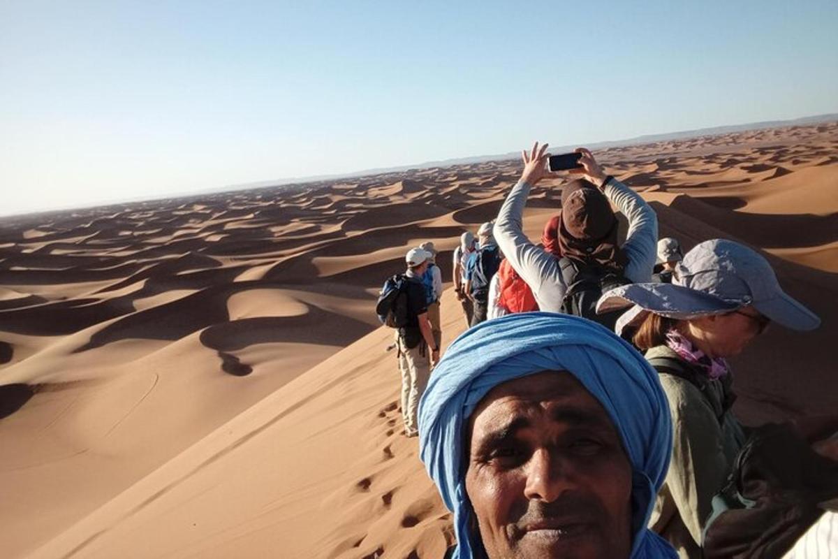 a group of people walking through the desert