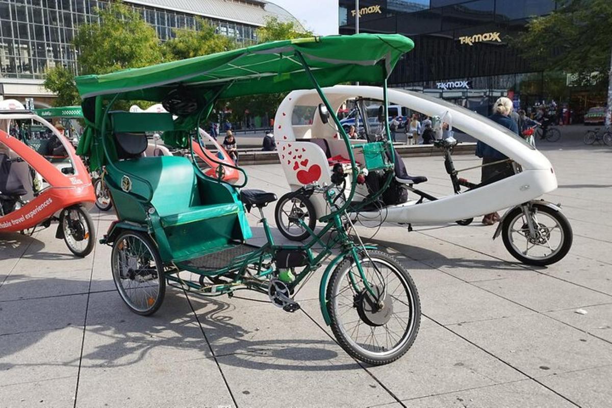 a green and white bike pulling a green and white carriage