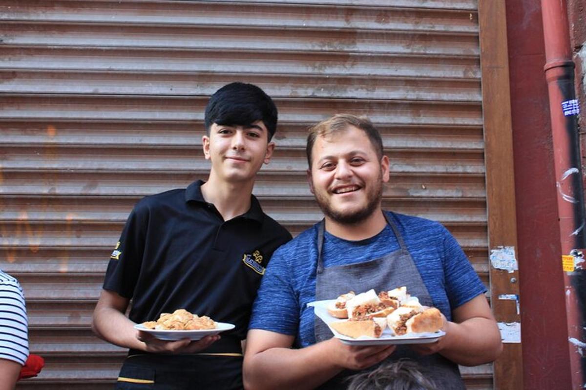 two men holding plates of food in their hands
