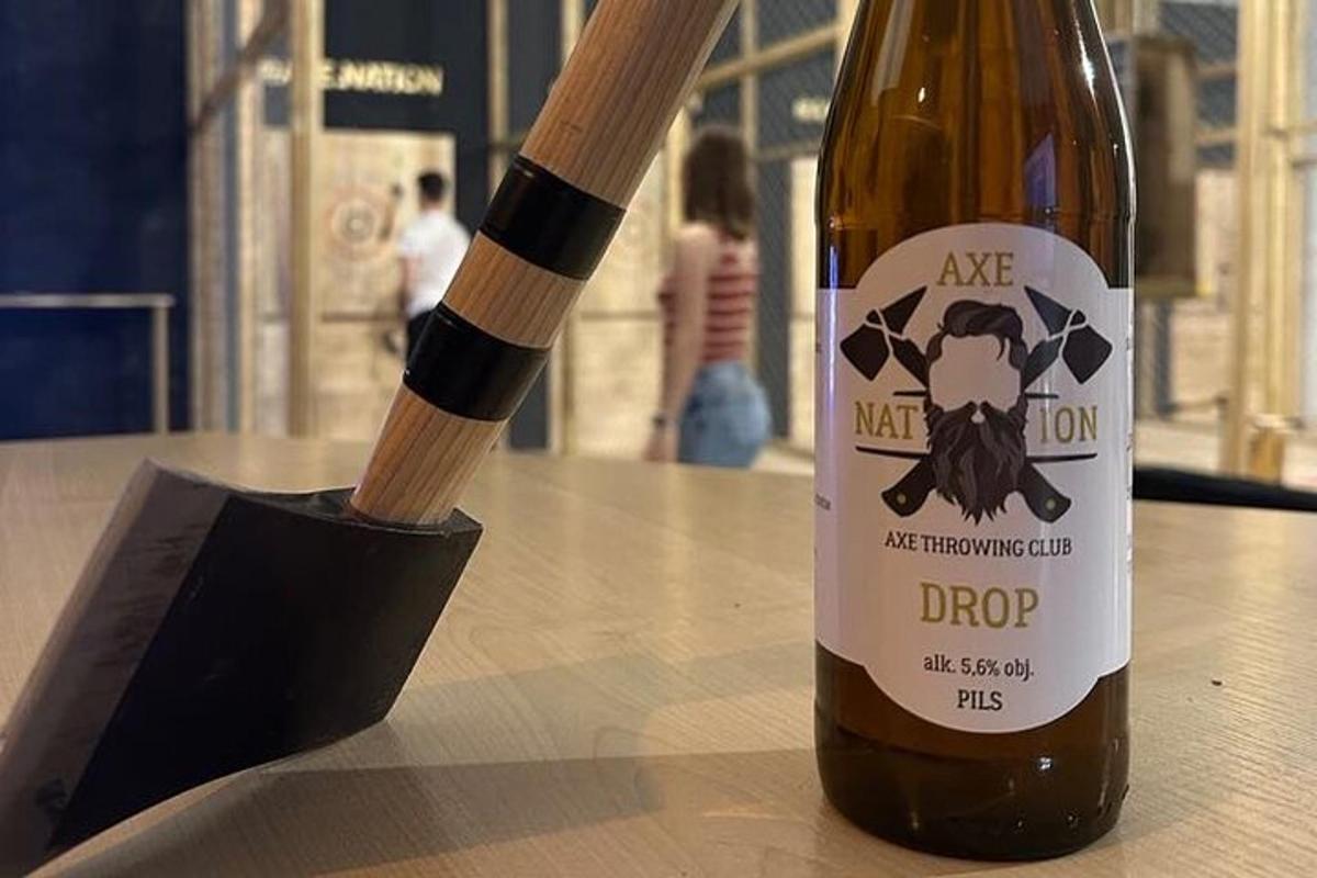 a bottle of wine on a table with a wooden stick