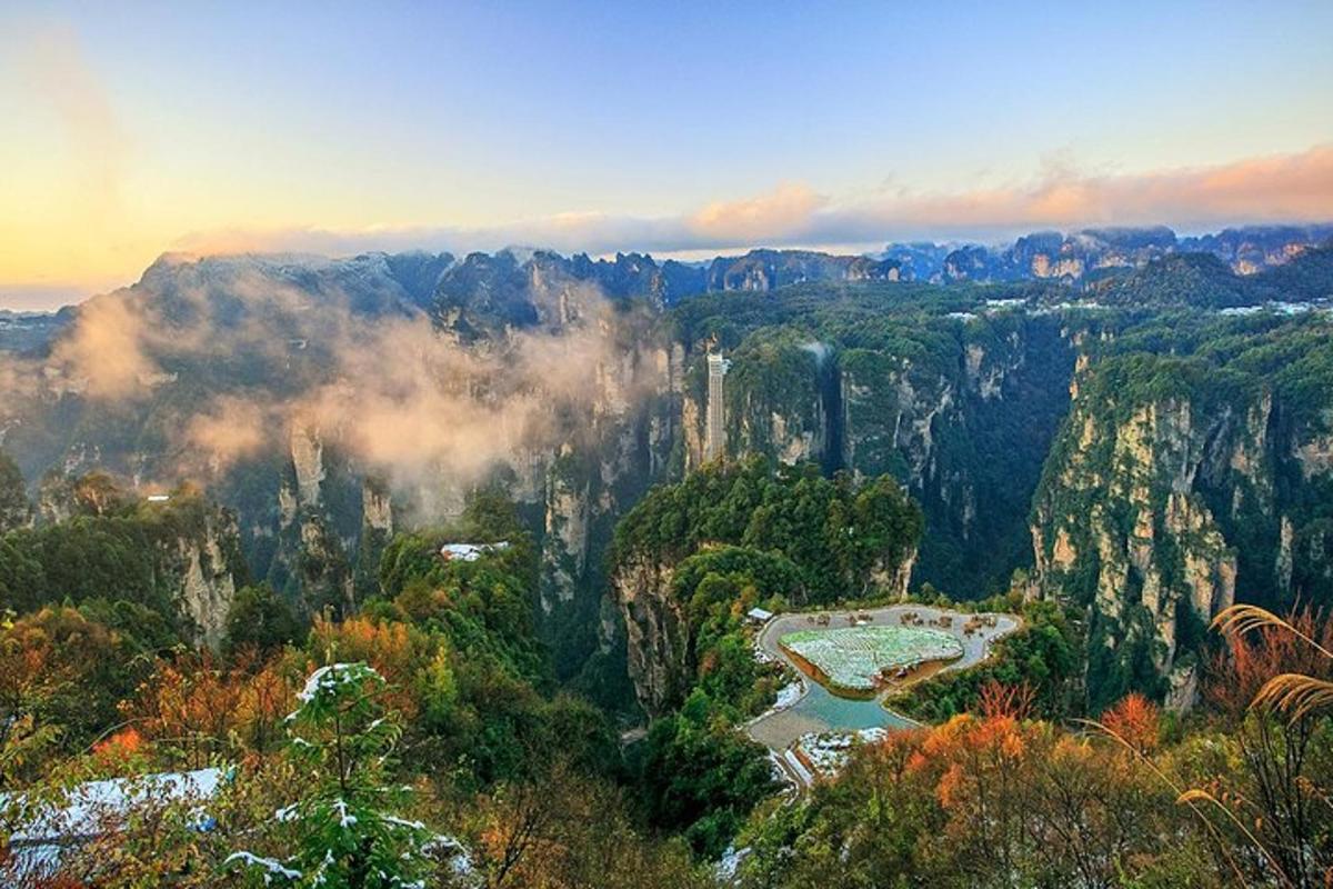 a view of a mountain with trees and a river