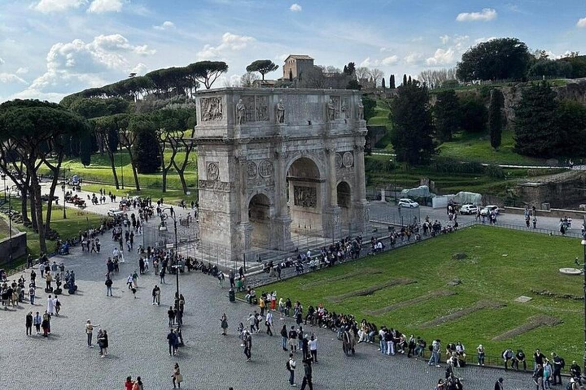 a large group of people walking around a monument