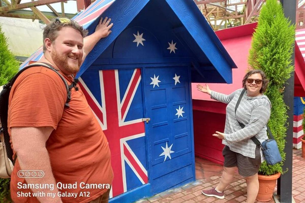 a man and a woman standing in front of a blue door