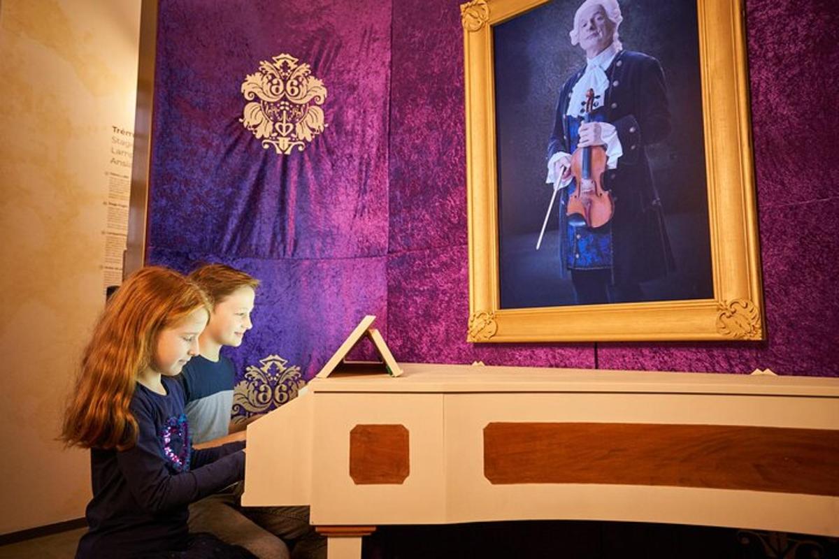 two girls looking at a picture of a man with a violin