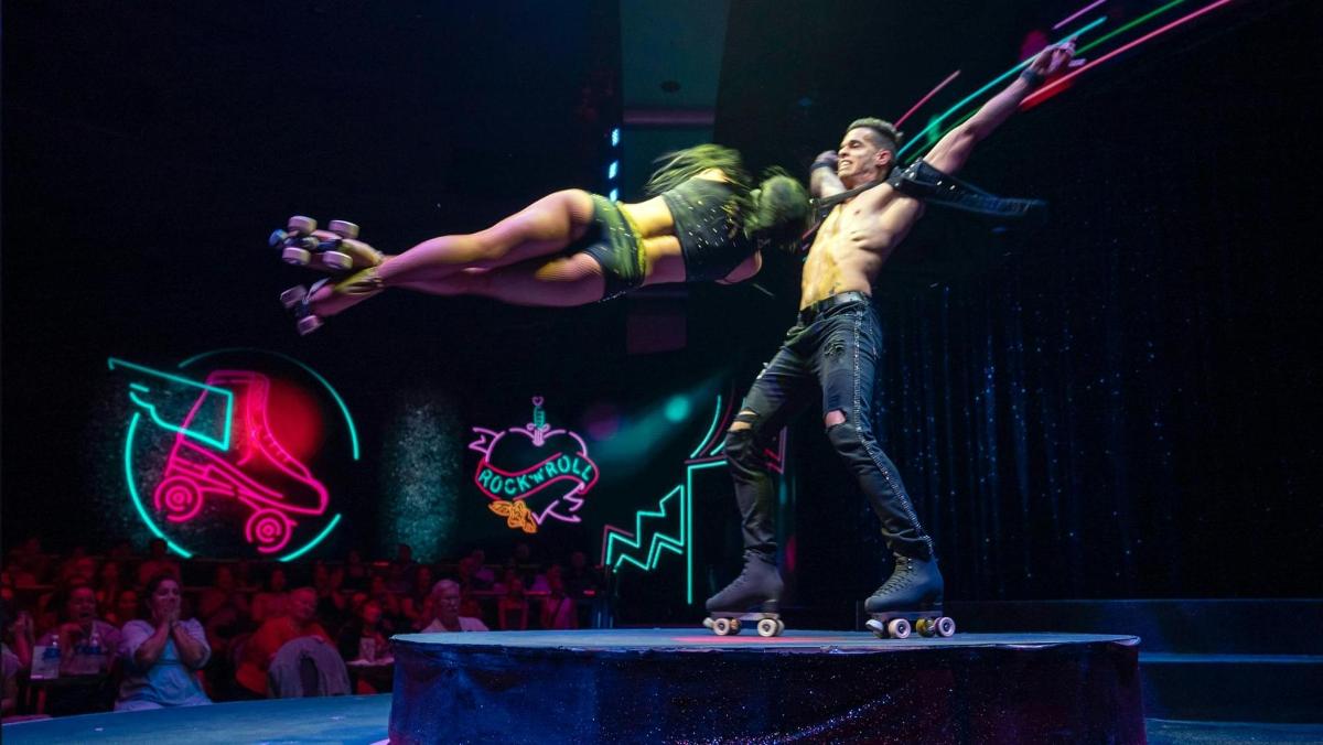 a man and a woman on skateboards on a stage