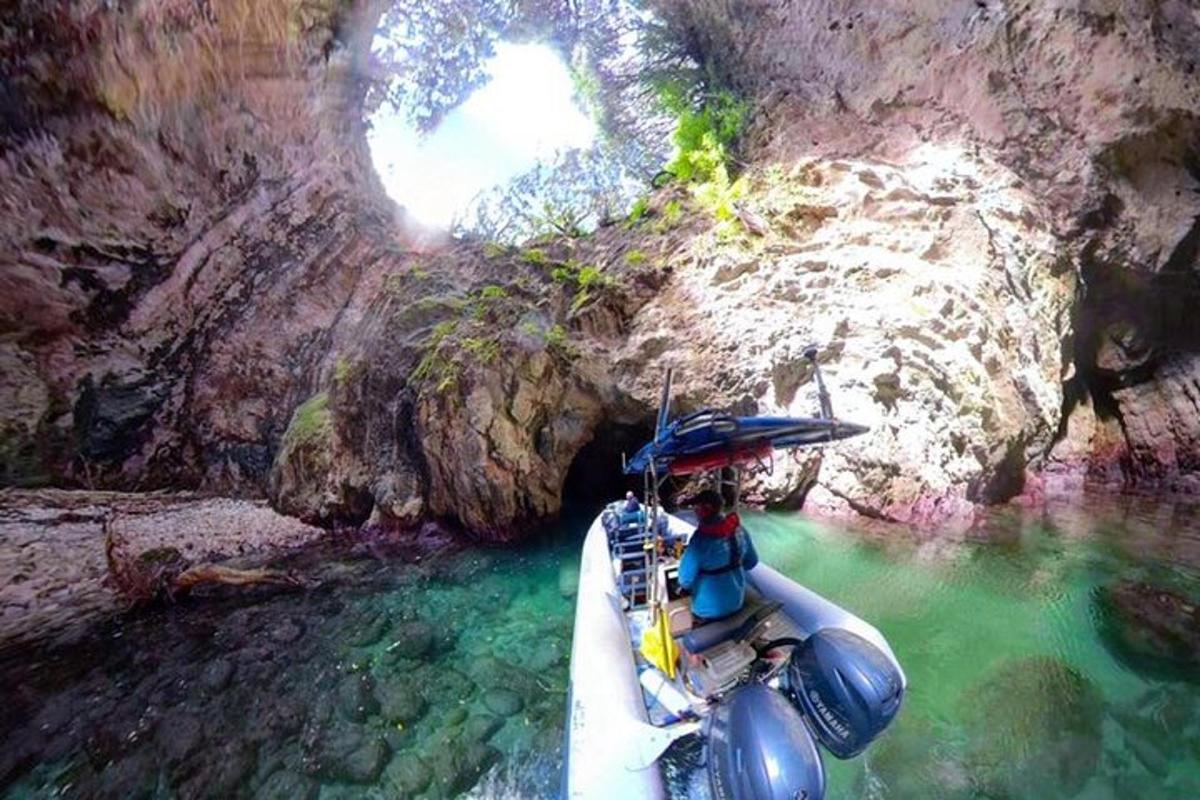 a person in a boat in a cave with an umbrella