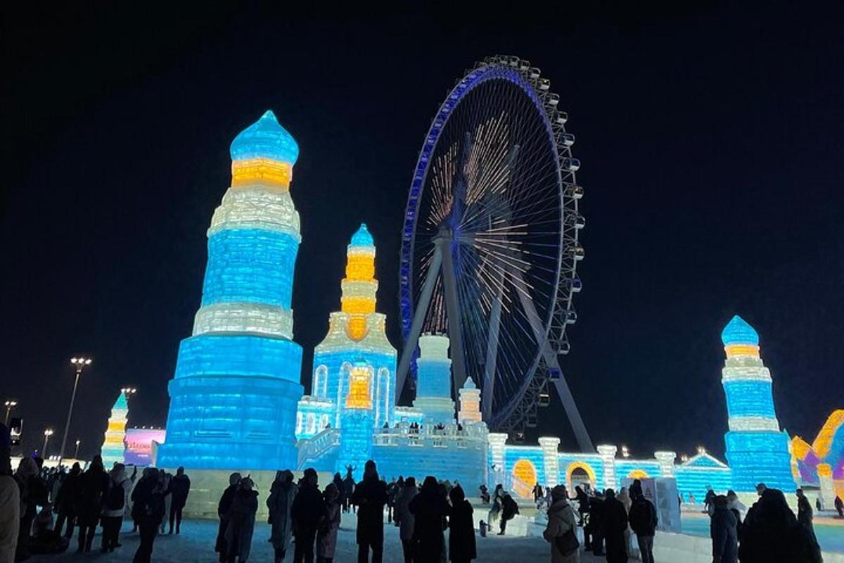 a large ice structure with a ferris wheel in the background