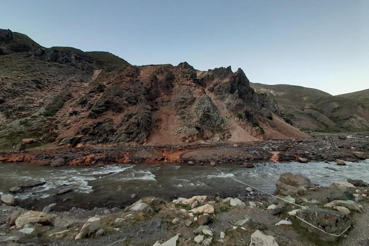 a mountain next to a river with a mountain
