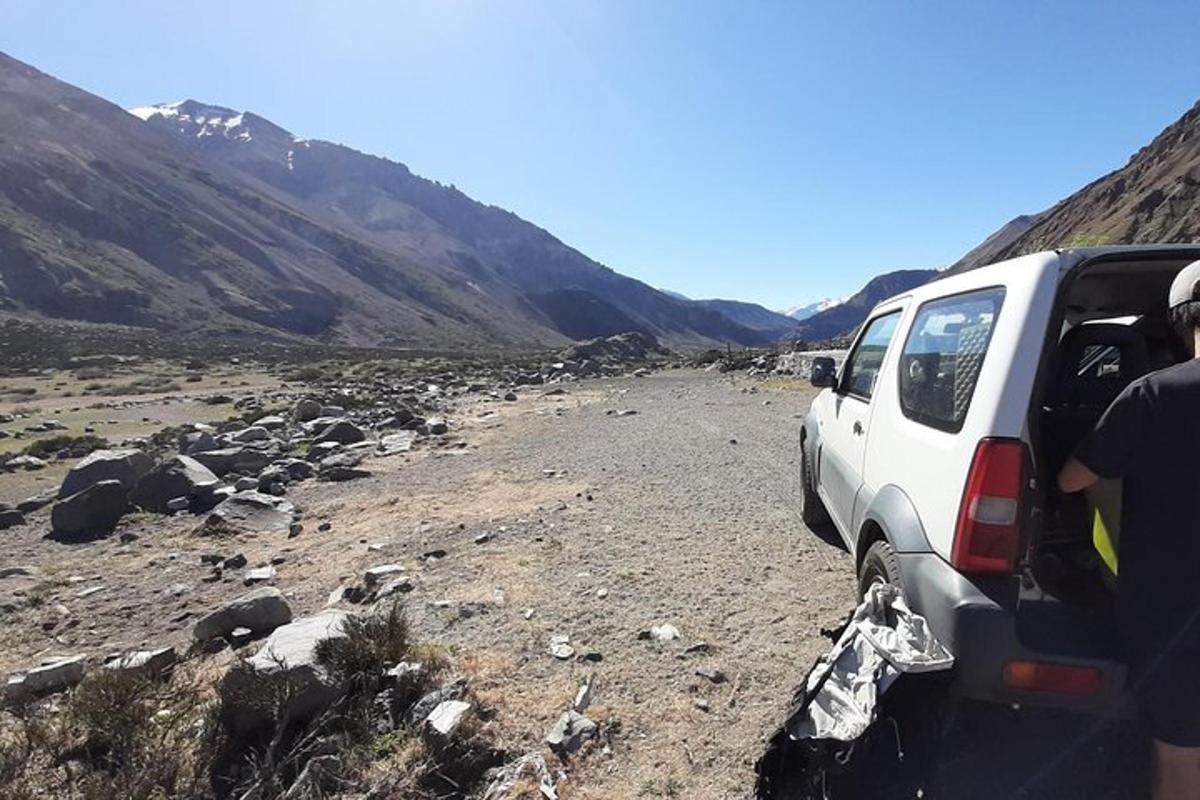 a suv parked on a dirt road in a valley