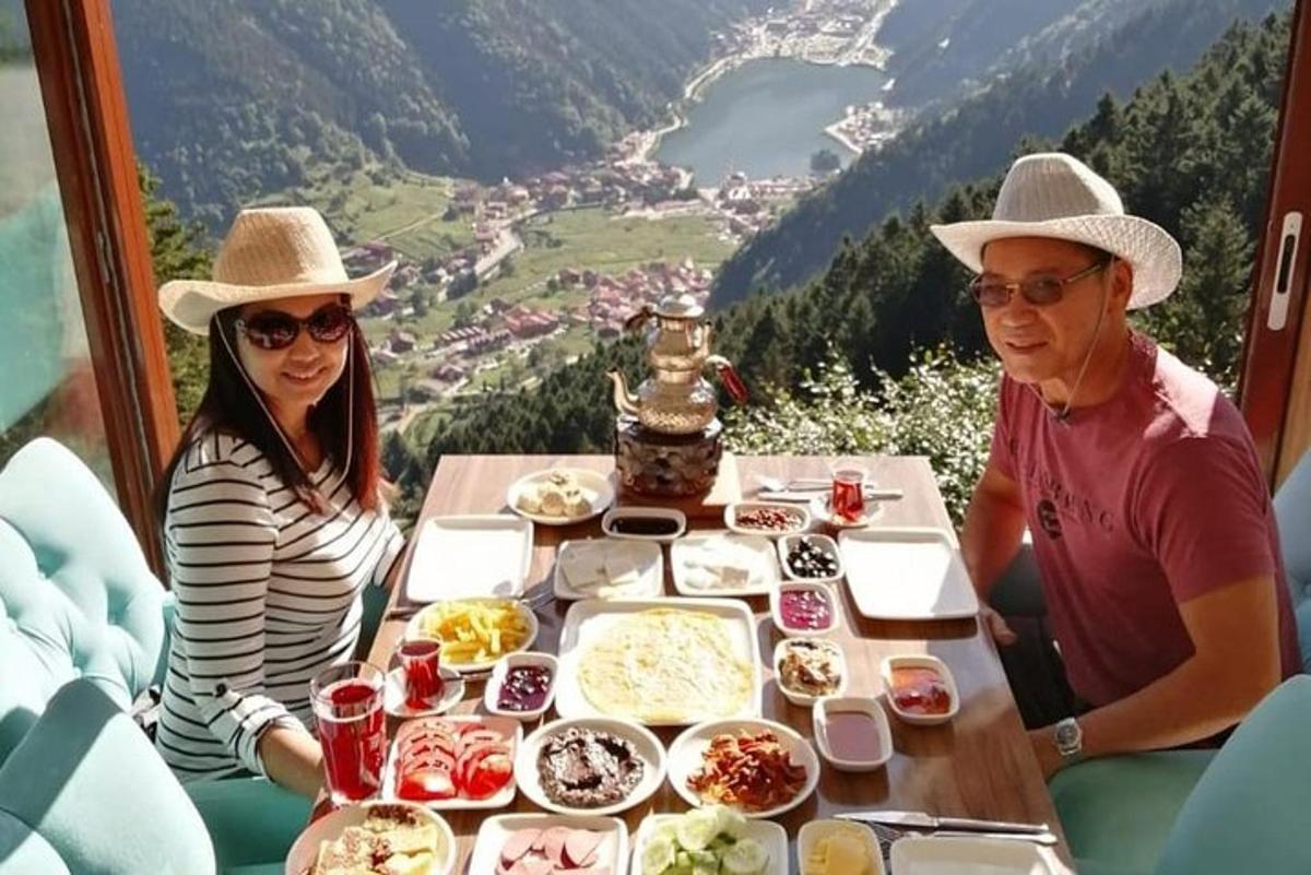 a man and woman sitting at a table with food