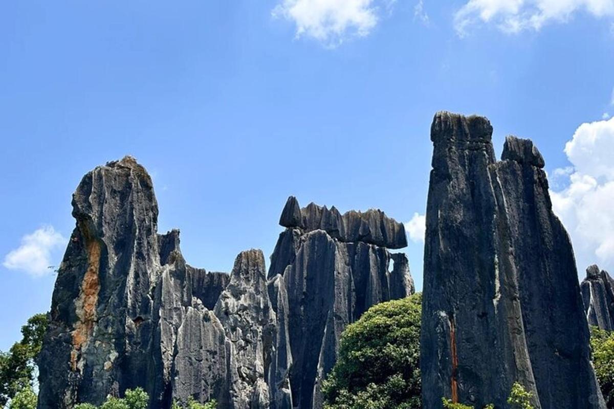 a group of tall rocks in front of a blue sky
