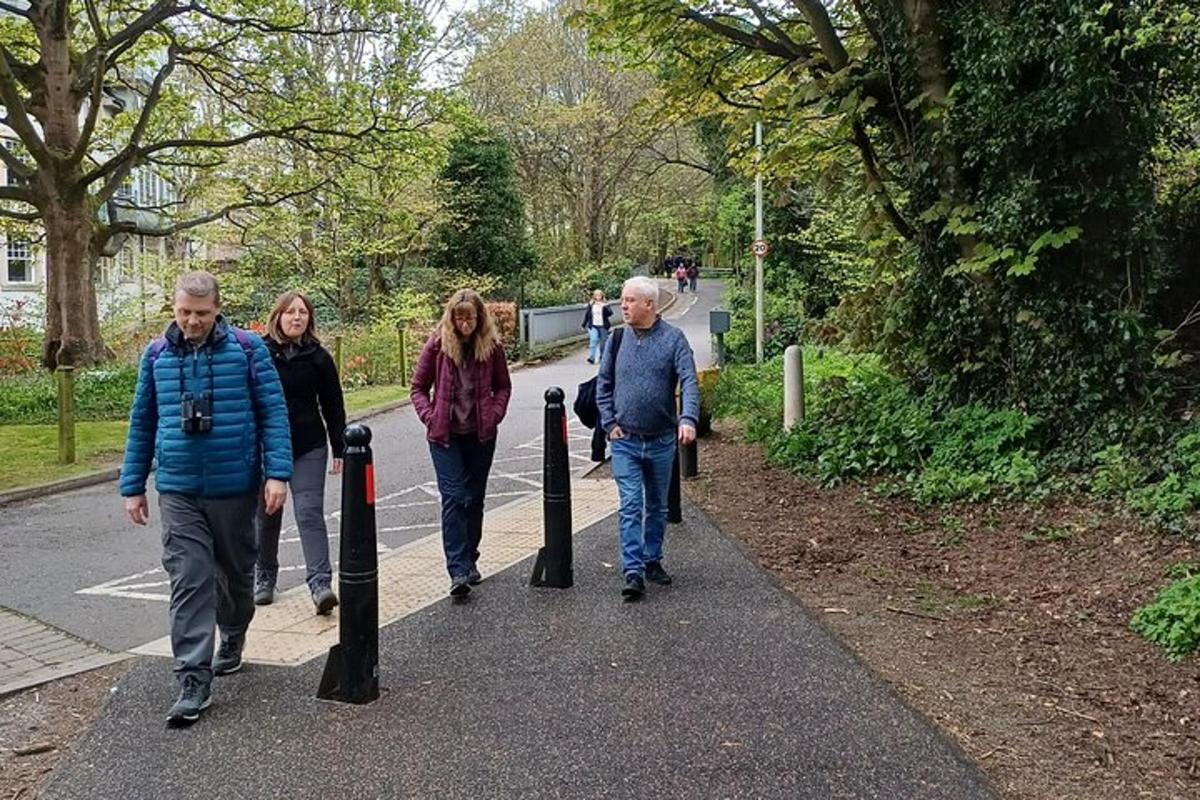 a group of people walking down a sidewalk