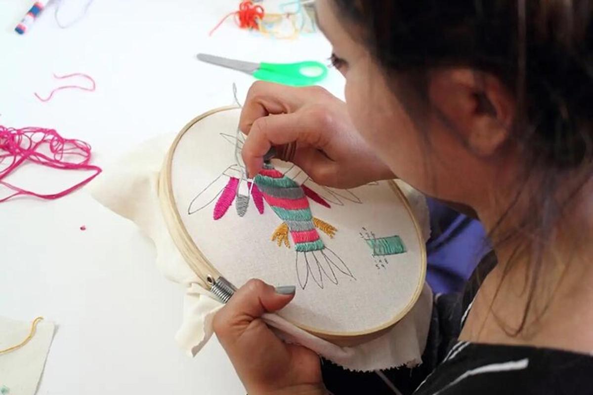 a woman is drawing on a plate with scissors